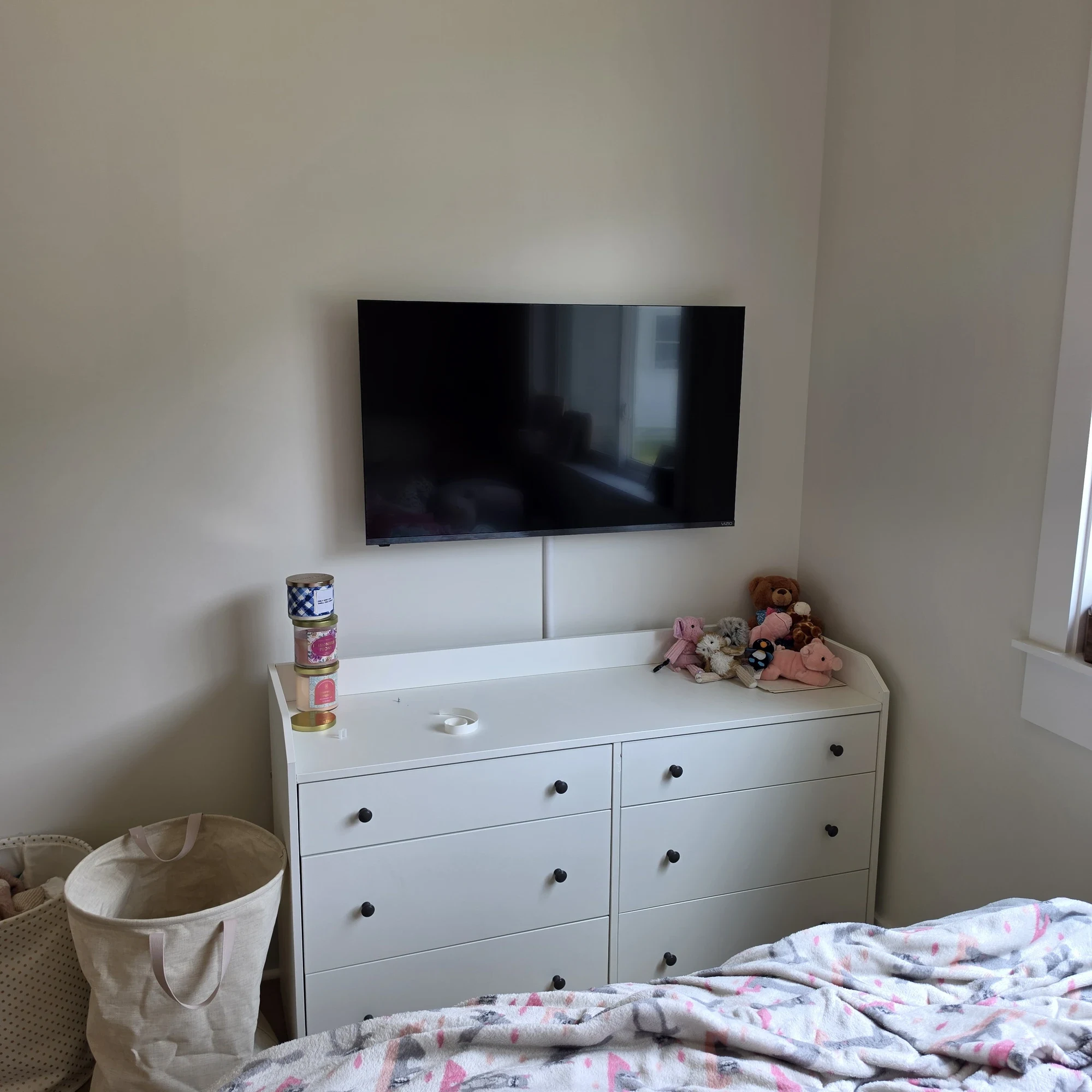 Bedroom TV wall mounted above a dresser